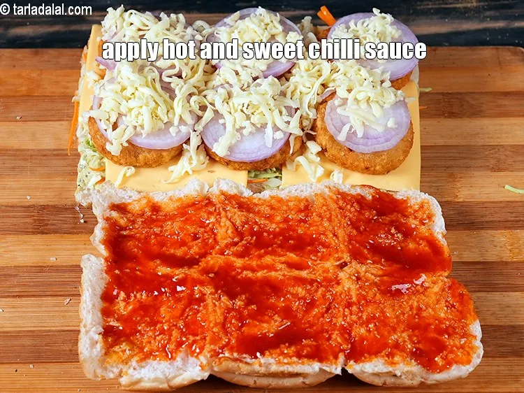Step 20 – Apply 3 tbsp <a href="https://www.tarladalal.com/glossary-hot-and-sweet-chilli-sauce-1600i">hot and sweet chilli sauce</a> on the upper halve of the …