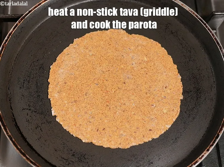 Step 17 – Heat a non-stick tava (griddle) and cook the parota.