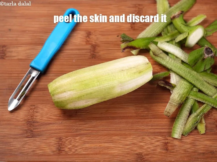 Step 17 – Peel the skin on the raw banana and discard it.