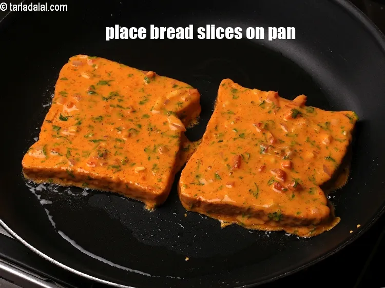 Step 18 – Place 2 <a href="https://www.tarladalal.com/glossary-bread-219i">bread</a>&nbsp;slices on pan.