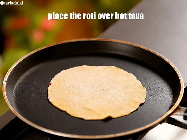 Step 17 – Heat a non-stick tava (griddle) and place the rolled roti over it.