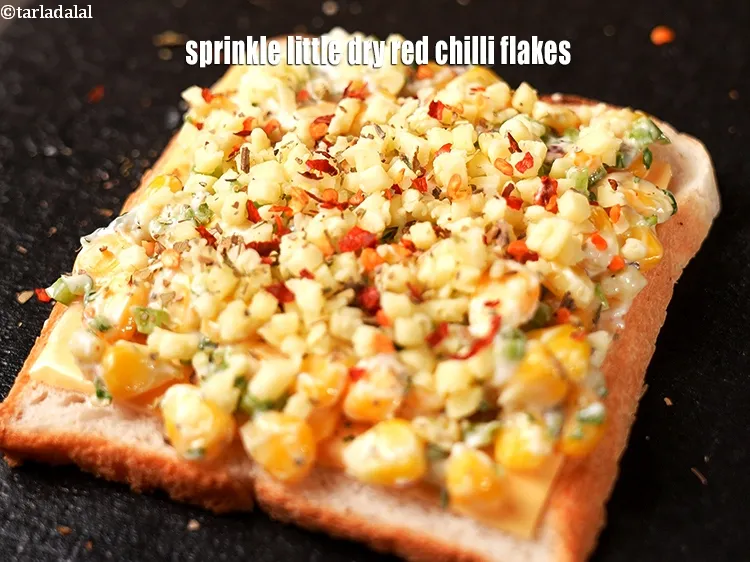 Step 17 – Sprinkle little <a href="https://www.tarladalal.com/glossary-dry-red-chilli-flakes-paprika-338i">dry red chilli flakes (paprika)</a>.