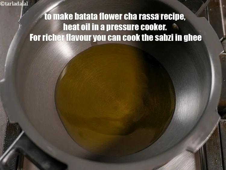 Step 17 – To make<strong> batata flower cha rassa recipe</strong>, heat 4 tbsp <a href="https://www.tarladalal.com/glossary-oil-671i">oil</a> in a pressure …