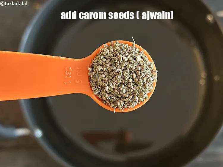 Step 17 – <html><head></head><body><p>Add&nbsp;1 tsp&nbsp;<a href="glossary-carom-seeds-ajwain-thymol-seeds-bishops-weed-266i">carom seeds (ajwain)</a>.</p></body></html>