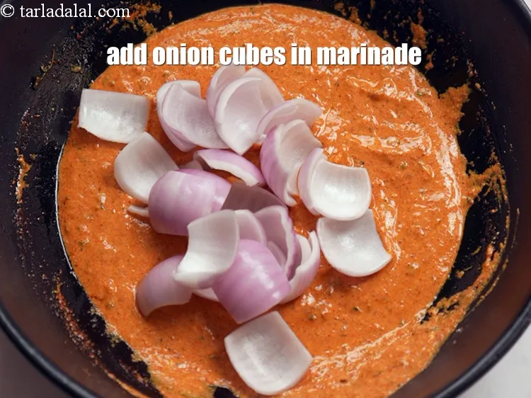Step 17 – Add 3/4 cup <a href="https://www.tarladalal.com/glossary-onion-cubes-732i">onion cubes</a> in the marinade.