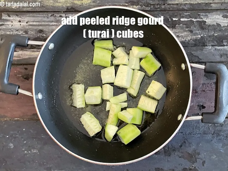 Step 18 – Add&nbsp;<meta charset="UTF-8" />1/2 cup&nbsp;peeled&nbsp;<a href="glossary-ridge-gourd-cubes-737i">ridge gourd (turai) cubes</a>.