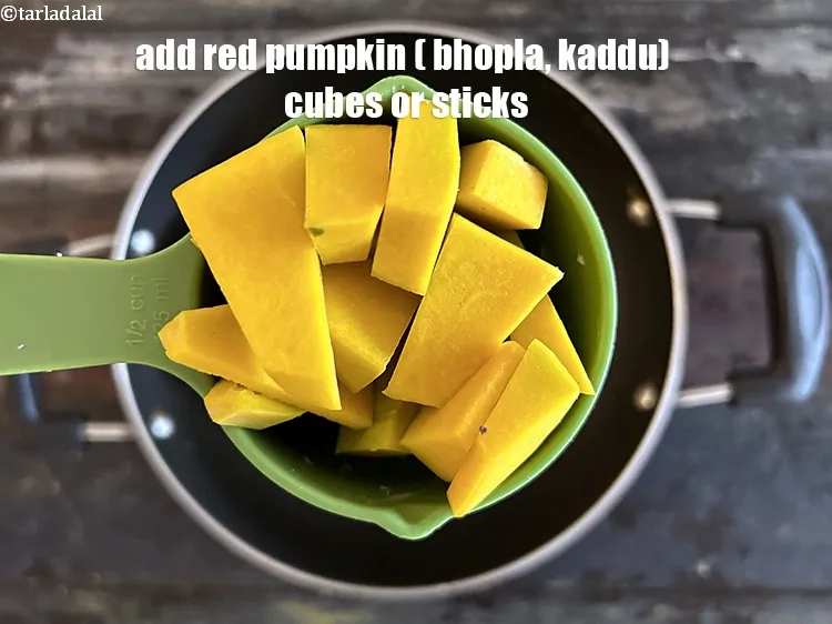Step 17 – Add&nbsp;<meta charset="UTF-8" />1/2 cup&nbsp;red pumpkin <strong>(bhopla / kaddu), cut into 25 mm ( 1 inch …