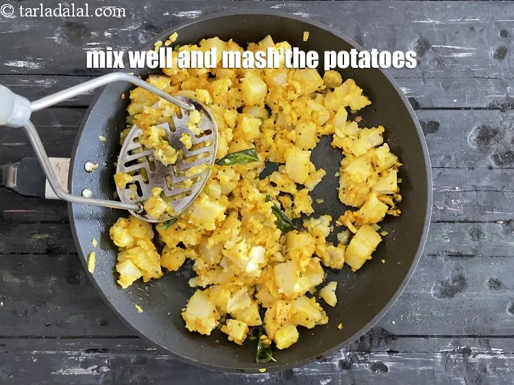 Step 60 – Mix well and mash the potatoes.