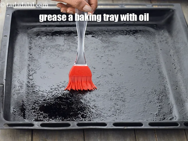 Step 15 – To prepare whole <strong>wheat bread rolls</strong>, grease a baking tray with oil and keep aside.