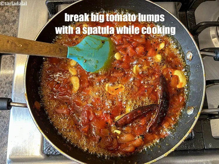 Step 19 – Break big tomato lumps with a spatula while cooking.