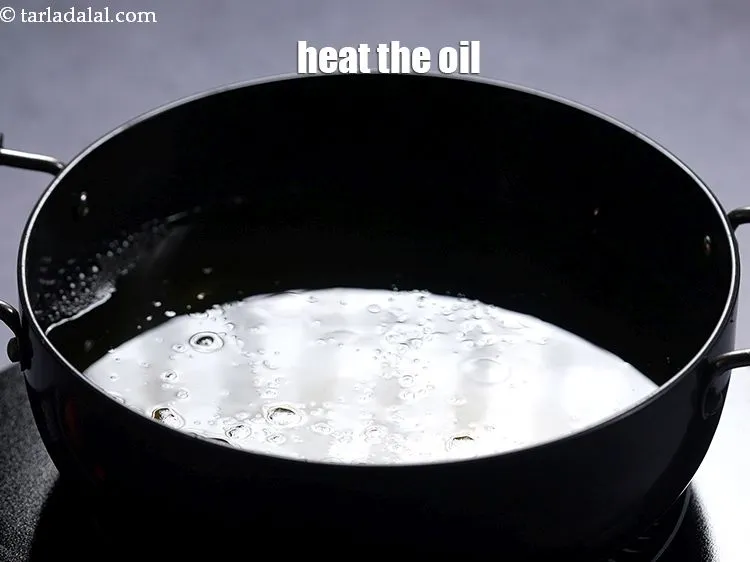 Step 23 – Heat the <a href="https://www.tarladalal.com/glossary-oil-671i">oil</a>&nbsp;in a deep non-stick pan.&nbsp;