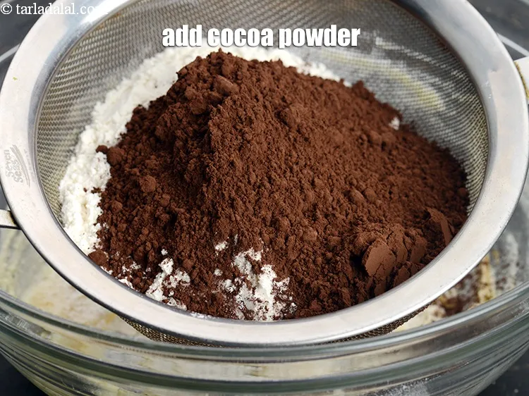 Step 17 – Add &frac14; cup <a href="https://www.tarladalal.com/glossary-cocoa-powder-284i">cocoa powder</a>.