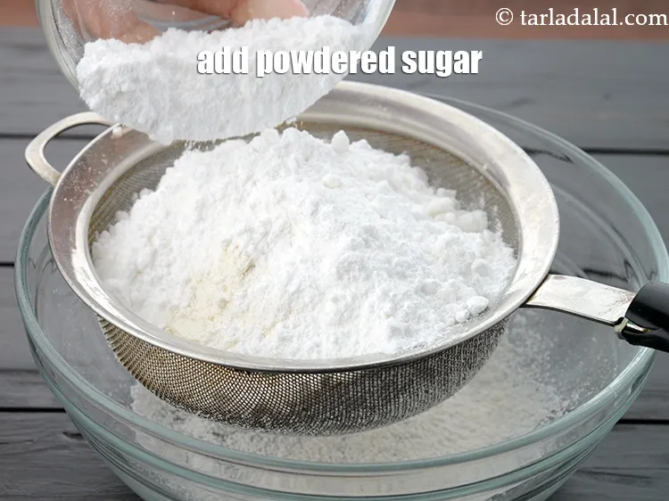 Step 17 – Add 1 cup <a href="https://www.tarladalal.com/glossary-powdered-sugar-280i">powdered sugar</a>.&nbsp;