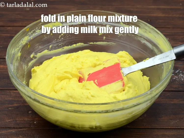 Step 18 – Fold in plain flour mixture by adding 1/4 cup&nbsp;<a href="https://www.tarladalal.com/glossary-milk-doodh-full-cream-milk-514i">milk</a>&nbsp;gradually and mix gently.&nbsp;