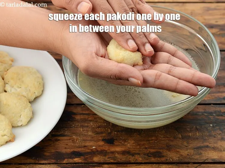 Step 49 – Squeeze each pakodi one by one in between your palms. Squeeze it very lightly to …