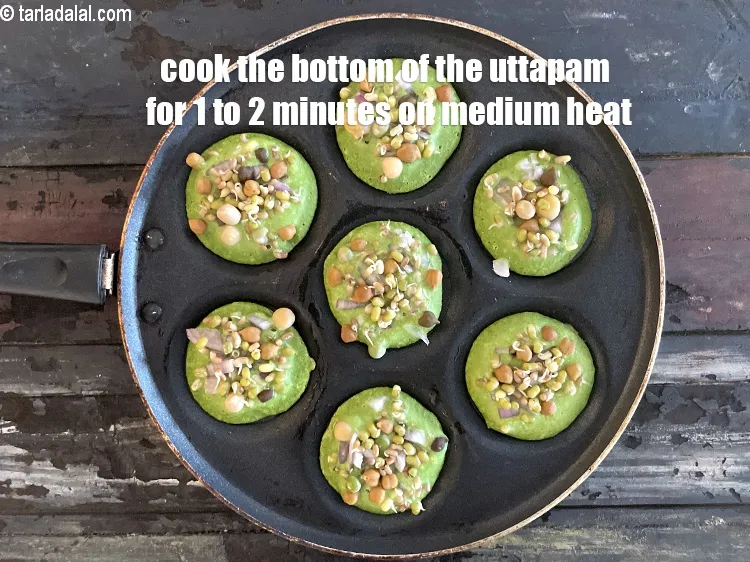 Step 24 – Cook the bottom of the uttapam for 1 to 2 minutes on medium heart.