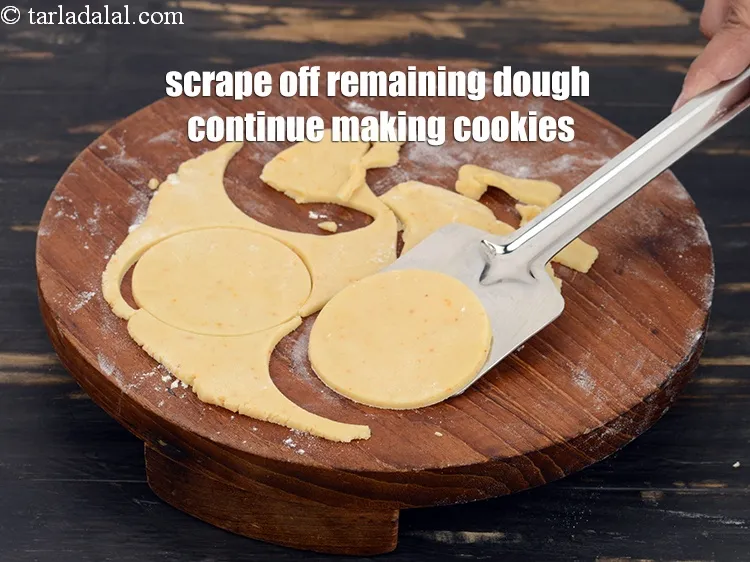 Step 17 – Scrape off the dough remaining after cutting the cookie rounds and continue making more cookies.
