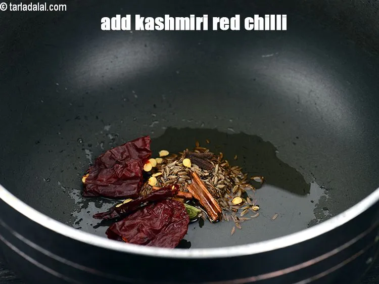 Step 17 – Add 1 <a href="https://www.tarladalal.com/glossary-whole-dry-kashmiri-red-chillies-kashmiri-mirch-kashmiri-lal-mirch-332i">whole dry kashmiri red chilli</a>, broken into pieces.