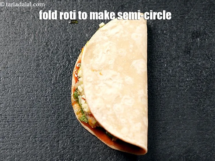 Step 17 – Fold the roti to make semi-circle.