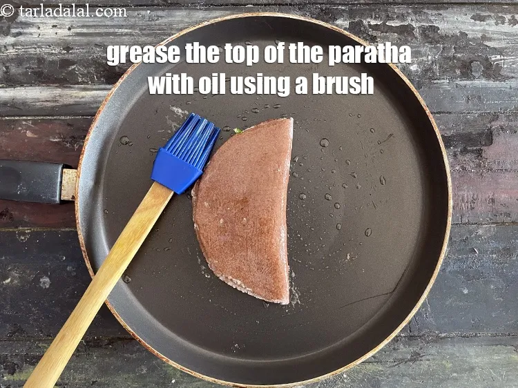 Step 22 – Grease the top of the paratha using a brush with oil.