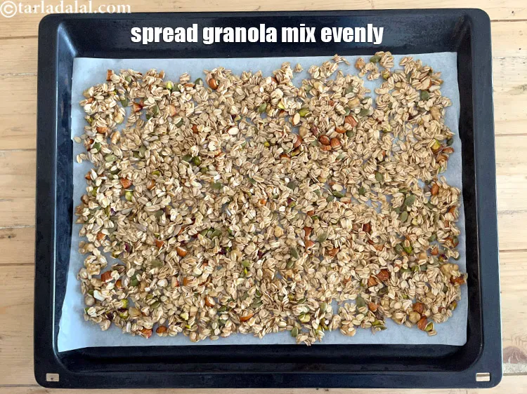 Step 20 – Spread the healthy Indian granola mix evenly over the baking tray.