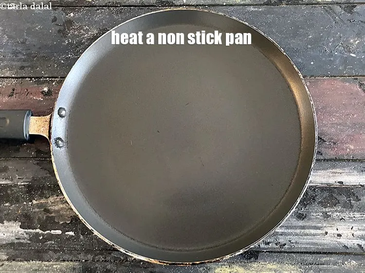 Step 17 – <meta charset="UTF-8" /> Heat a non-stick tava (griddle).