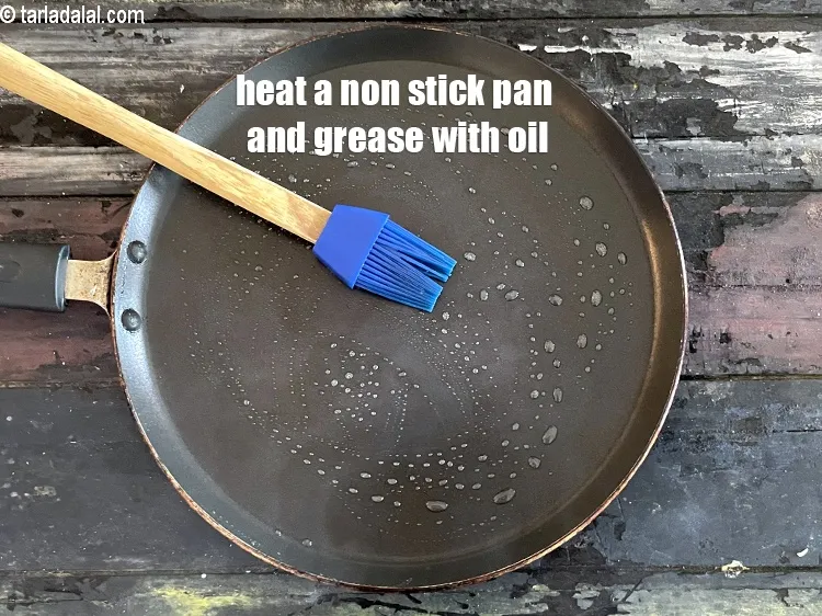 Step 30 – <meta charset="UTF-8" />Heat a non-stick tava (griddle), grease it using &frac14; tsp of oil.