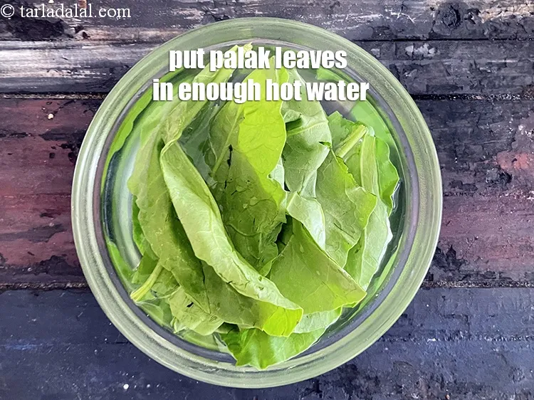 Step 18 – <meta charset="UTF-8" /> Put the <meta charset="UTF-8" />10&nbsp;<a href="glossary-spinach-palak-255i">spinach (palak)</a>&nbsp;leaves in enough hot water.