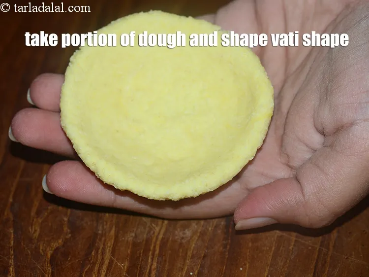 Step 20 – Take a portion of the dough and shape it into a vati shape.