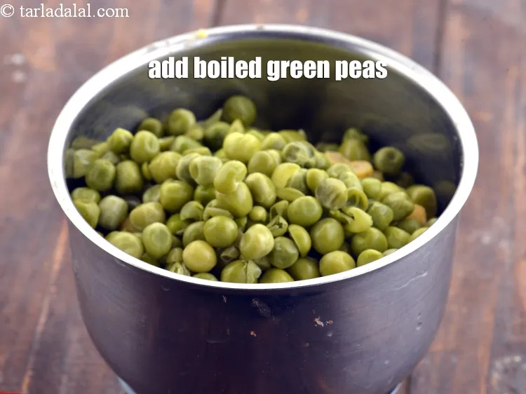 Step 16 – Add &frac12; cup <a href="https://www.tarladalal.com/glossary-boiled-green-peas-1078i">boiled green peas</a>.