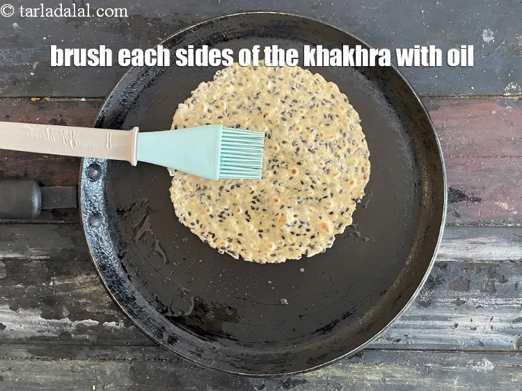 Step 16 – Brush both sides of the khakhra with oil.
