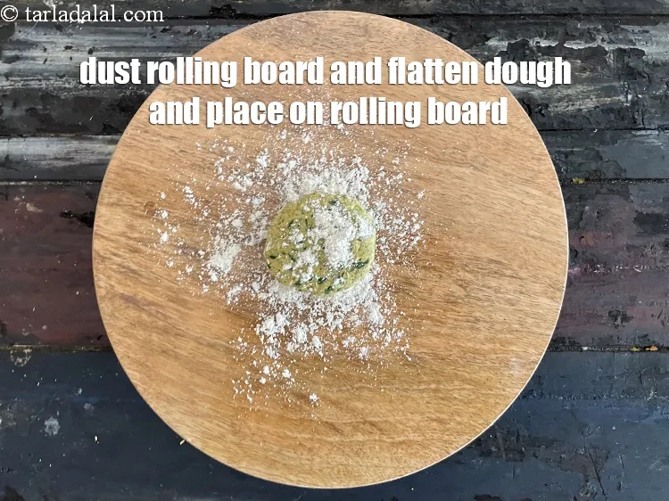 Step 19 – <meta charset="UTF-8" />Sprinkle a little&nbsp;<a href="https://www.tarladalal.com/glossary-whole-wheat-flour-gehun-ka-atta-gehun-ka-aata-429i">whole wheat flour (gehun ka atta)</a>&nbsp; on the rolling surface.&nbsp;Flatten …