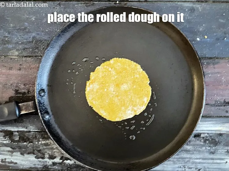 Step 21 – Place the rolled out&nbsp;<strong>Khakhra</strong>&nbsp;dough on it.&nbsp;