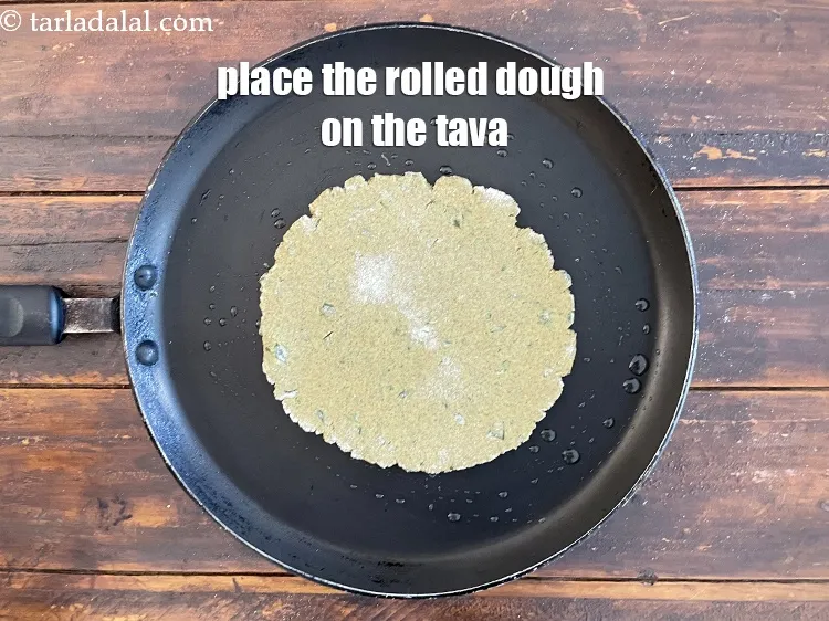 Step 17 – Place the rolled out&nbsp;<strong>Khakhra</strong>&nbsp;dough on it.