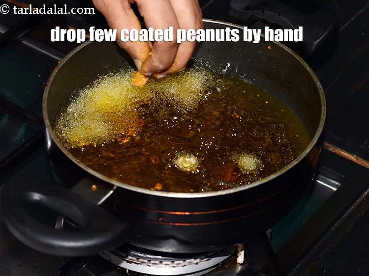 Step 17 – Drop a few coated peanuts by hand individually.