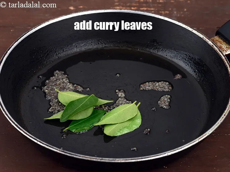 Step 17 – When the seeds crackle, add 5 to 6&nbsp;<a href="https://www.tarladalal.com/glossary-curry-leaves-kadi-patta-kadipatta-388i">curry leaves (kadi patta)</a>.