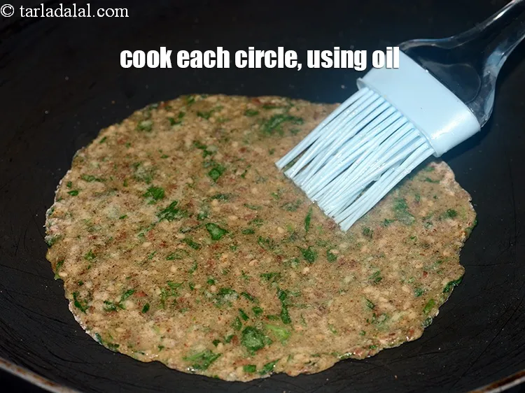Step 18 – <p>Cook each circle, using 1 tsp of <a href="https://www.tarladalal.com/glossary-oil-671i">oil</a>.&nbsp;</p>