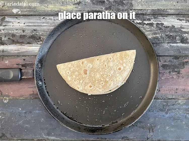 Step 39 – Place the paratha on tava.