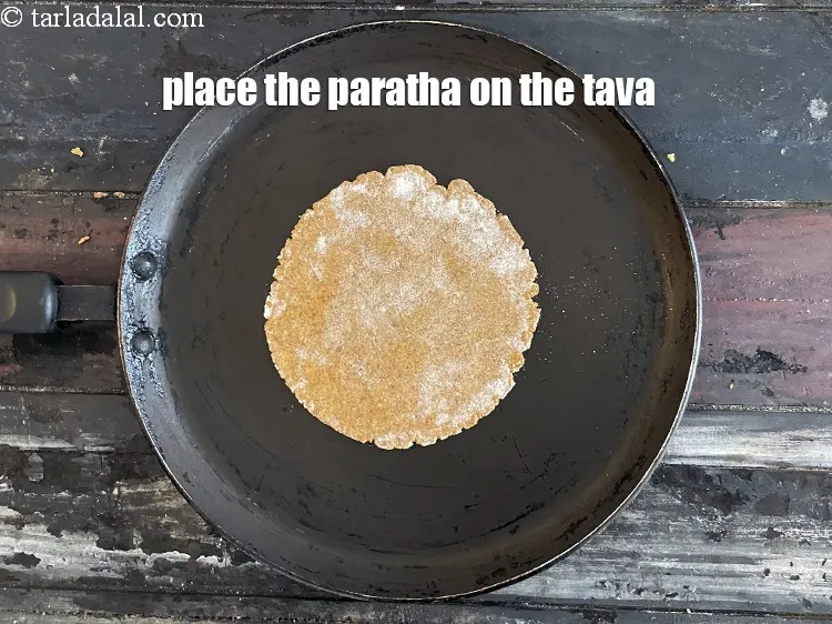 Step 19 – Place the paratha on the tava.