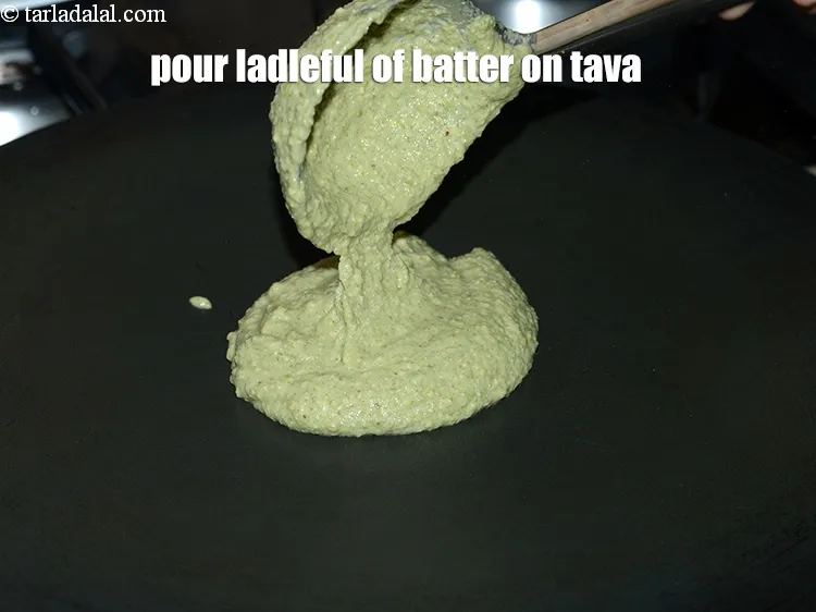 Step 17 – Pour a ladleful of the batter on the tava (griddle).