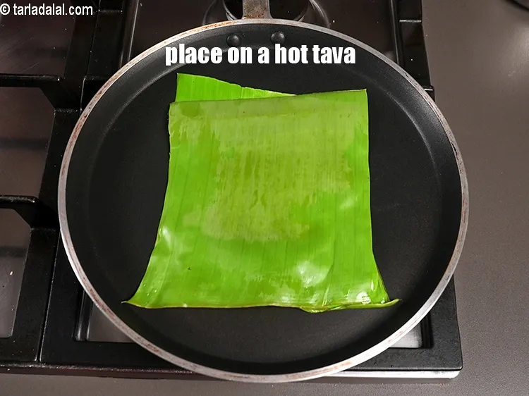 Step 20 – <meta charset="UTF-8" /> Place banana leaf on a hot tava.&nbsp;&nbsp;