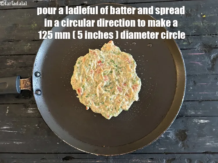 Step 18 – Pour a ladleful of the batter and spread in a circular motion to make a …