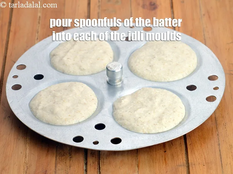 Step 17 – Pour spoonfuls of the batter into each of the idli moulds.