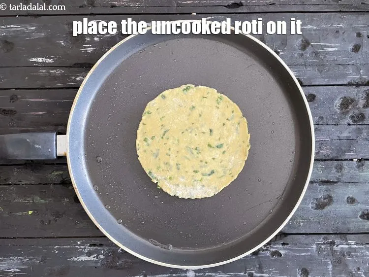 Step 18 – <meta charset="UTF-8" />Place the uncooked roti on it.&nbsp;<br /> &nbsp;