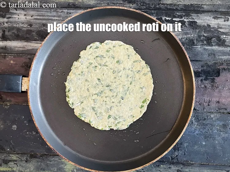 Step 18 – Place the uncooked roti on it.