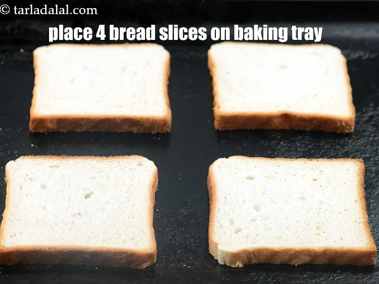 Step 17 – Place 4&nbsp;<a href="https://www.tarladalal.com/glossary-bread-219i">bread</a>&nbsp;slices on a baking tray.&nbsp;