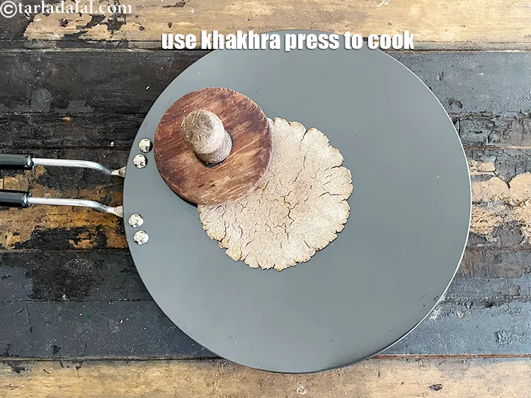 Step 28 – Then use a khakhra press to press down and cook both sides again.