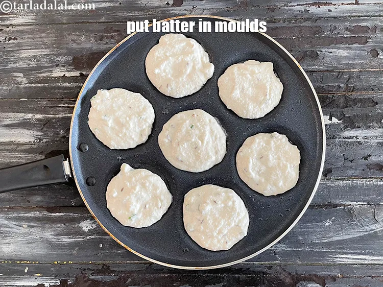 Step 18 – Pour 2 tbsp of the batter in each uttapa mould and spread it lightly.