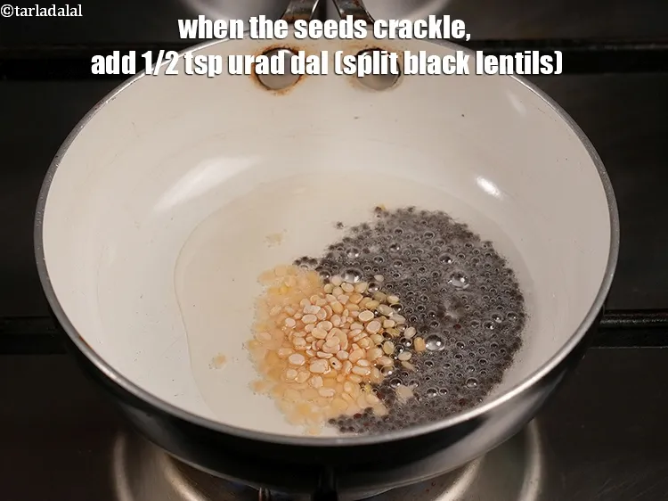 Step 18 – When the seeds crackle, add&nbsp;<meta charset="UTF-8" />1/2 tsp&nbsp;<a href="glossary-urad-dal-split-black-lentil-941i">urad dal (split black lentils)</a>.