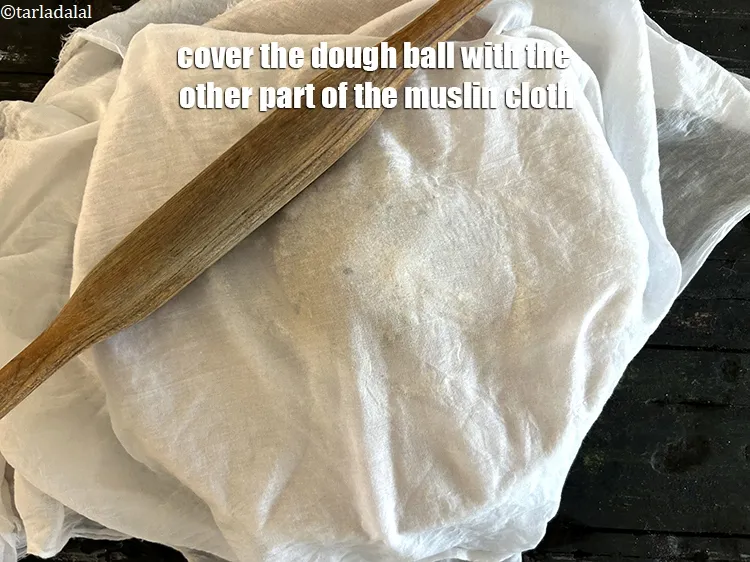 Step 18 – Cover the flattened dough ball with the other part of the muslin cloth.